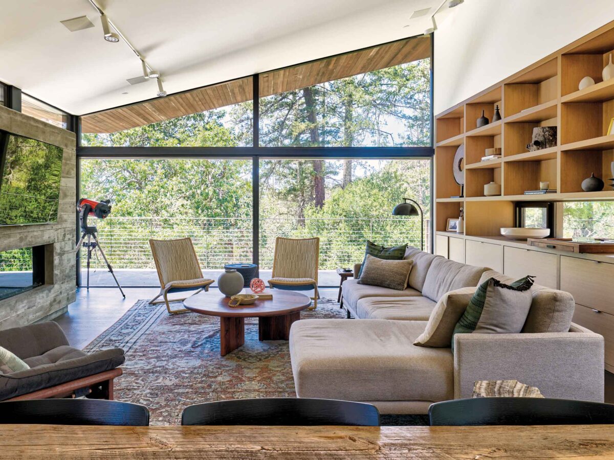 A welcoming living room with generous windows and warm natural details